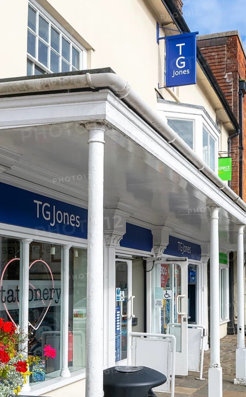 TG Jones shop signage rebranded WH Smith store, High Street, Marlborough, Wiltshire, England, UK