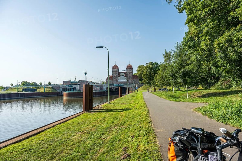 Bicycle standing on a canal path next to a lock, surrounded by green nature, Minden waterway junction, Minden-Lübbecke, North Rhine-Westphalia