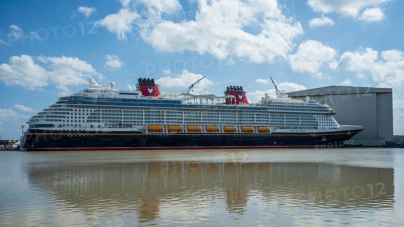 A large cruise ship moored next to a shipyard on a sunny day, cruise ship at the Meyer Werft shipyard in Papenburg