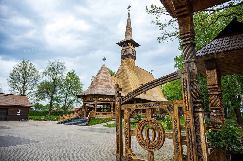 Unique wooden church with ornate carvings and horse shoes on the Tor tor, surrounded by trees, The Romanian Orthodox church near Sögel in Emsland