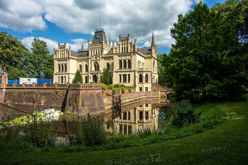 Gothic castle in perspective with moat surrounded by green landscape, Evenburg Castle, Leer, East Frisia