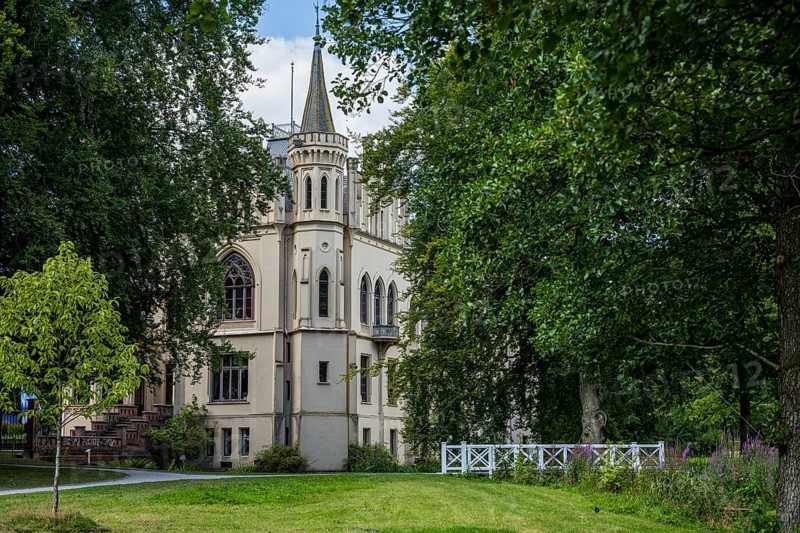 A castle with Gothic elements, surrounded by green landscape and trees, Schloss Evenburg, Leer, East Frisia