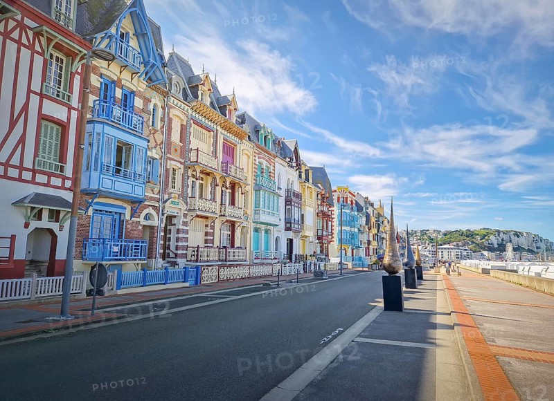 Charming Belle Epoque villas of Mers-les-Bains coastline town, arranged along the seaside promenade. Distinctive half-timbered architecture of different bright colors in Picardy, France