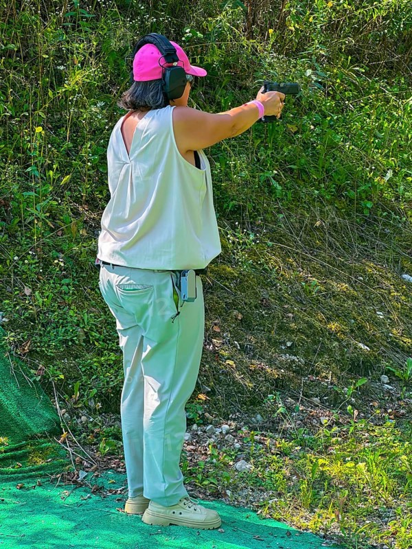 Woman Shooting on an Outdoor IPSC Shooting Range in a Sunny Summer Day in Switzerland