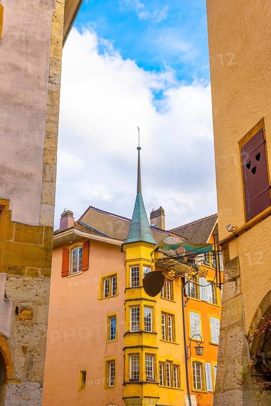 Old Town with Corner House with Tower and Sky and Clouds in a Sunny Autumn Day in City of Biel, Bienne, Bern Canton, Switzerland