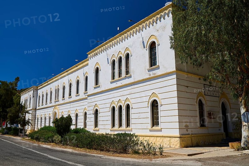 Marine Administration, Caserma Marina 1930, Today Municipal Administration, Large white building with arches and many windows under a clear sky, Historicism, Art Deco, Rationalism, Portolago, Lakki, Leros, Dodecanese, Greek Islands, Greece