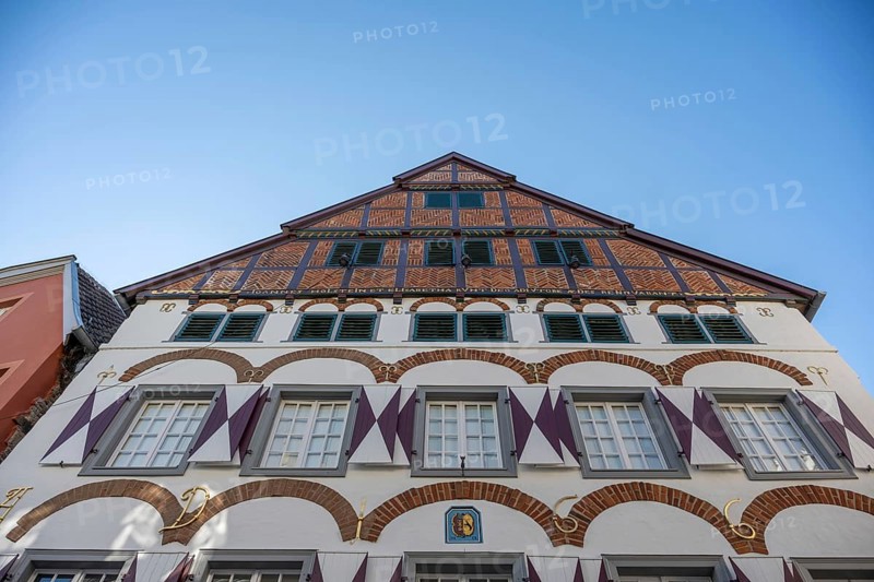 Half-timbered house with striking gables and windows, against a blue sky, Warendorf, Münsterland, North Rhine-Westphalia