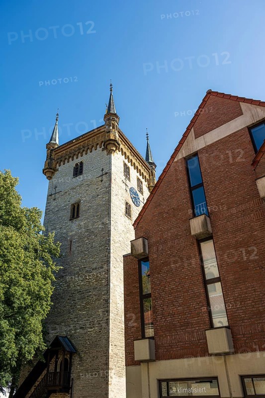 Historic tower and modern building, surrounded by trees, under a blue sky, tower of the old St Mary's Church, Warendorf, Münsterland, North Rhine-Westphalia