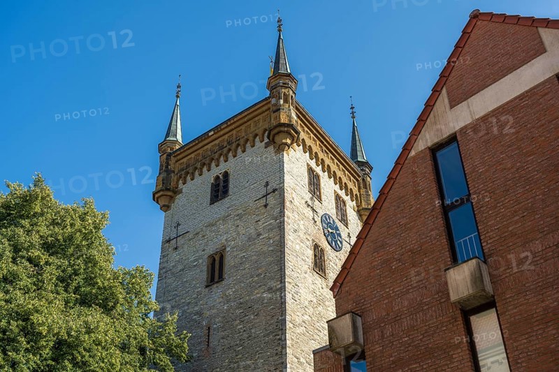 Old tower next to a modern building, in a clear blue sky, tower of the old St Mary's Church, Warendorf, Münsterland, North Rhine-Westphalia