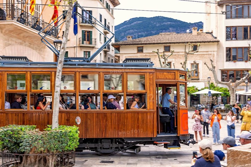 Vintage tramcar passing through town square in the centre of Sóller with tourists, Soller, Mallorca, Spain