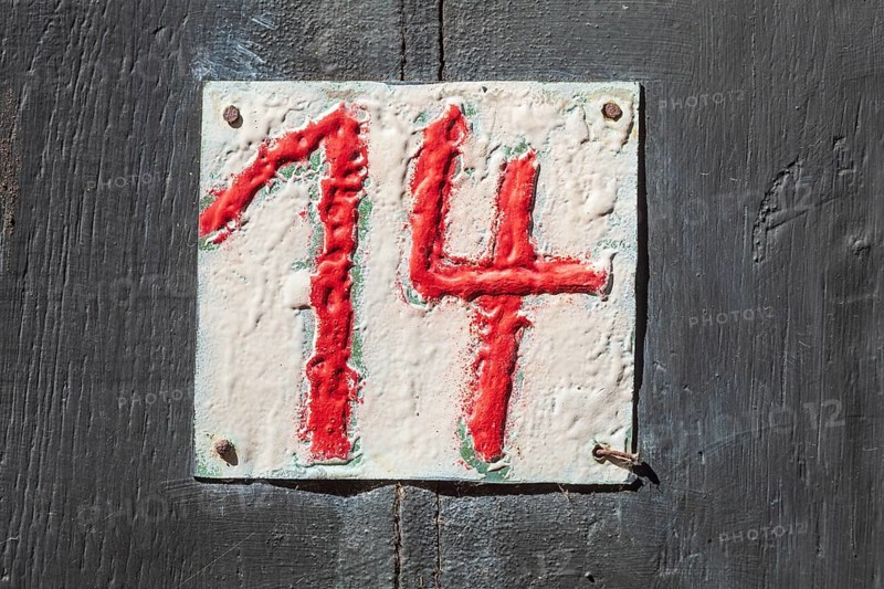 House number sign number fourteen on a half-timbered house in the old town centre, Hameln, Lower Saxony, Germany