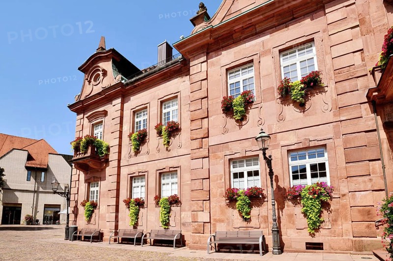 Ettlingen, Germany - August 13th 2025: Part of Ettlingen city hall (Rathaus) in Germany. Historic sandstone building with baroque architecture and flowers