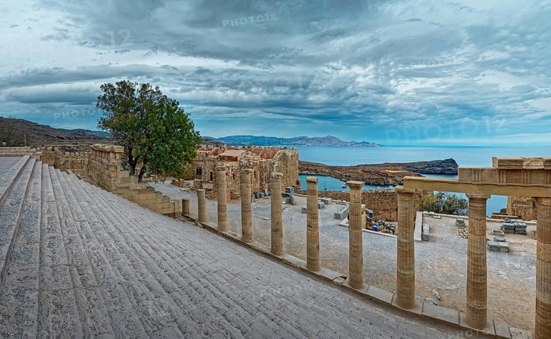 Ancient columns and staircase of the Acropolis of Lindos with a view of the sea and cloudy sky, Acropolis, Lindos, Rhodes, Island, Greece
