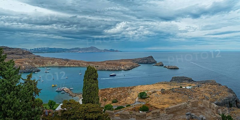 View of the coastal landscape of Lindos with the harbour full of boats, Acropolis, Lindos, Rhodes, Island, Greece