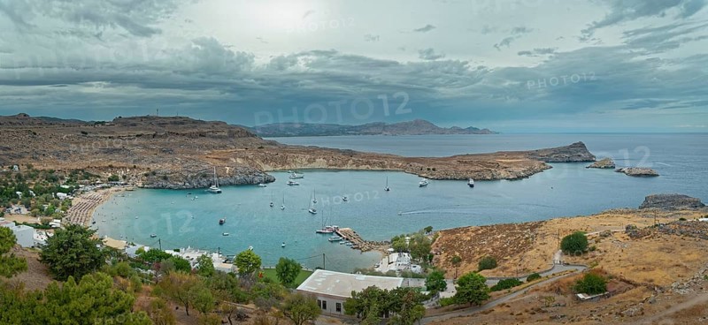 Harbour and coast of Lindos with boats and cloudy sky, Acropolis, Lindos, Rhodes, island, Greece