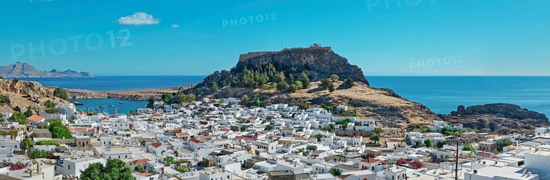 Panoramic view over the coastal landscape of Lindos with Acropolis and hills in the background, Acropolis, Lindos, Rhodes, Island, Greece