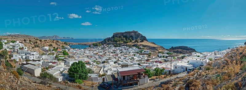 Panoramic view of the town of Lindos with Acropolis on the coast with a blue sky, Acropolis, Lindos, Rhodes, Island, Greece