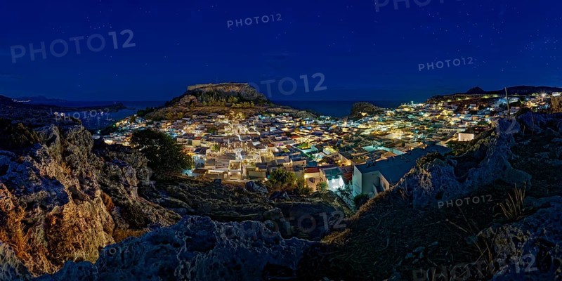 View of the illuminated town of Lindos with the ancient Acropolis under a starry sky with the sea, Acropolis, Lindos, Rhodes, Island, Greece