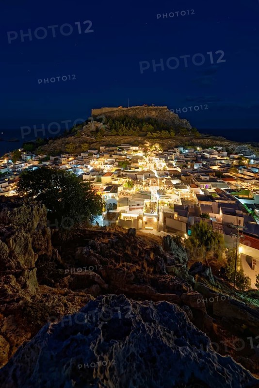 Night picture of the brightly lit town of Lindos and the ancient Acropolis on a rock in the background, Acropolis, Lindos, Rhodes, Island, Greece