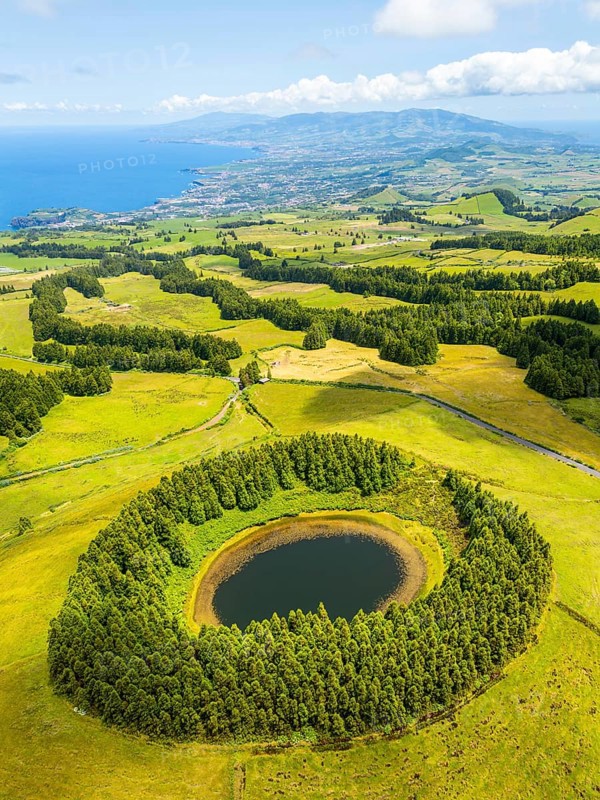 Pond Pau Pique and Lush Green Hills with Pasturelands. Atlantic Ocean. Azores, Sao Miguel Island. Portugal. Aerial Drone Shot