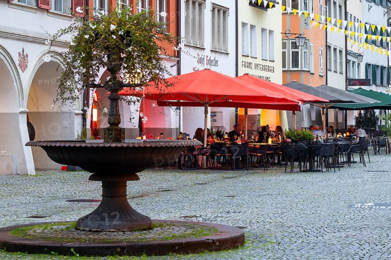 Fountain, outdoor seating of a restaurant, sunshades, market square, Feldkirch, Vorarlberg, Austria