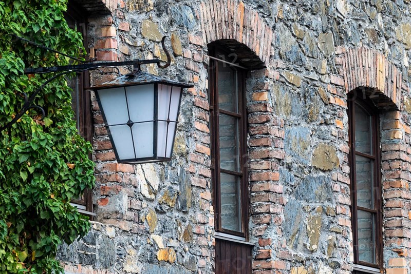 Old stone façade, historic lantern, Mühletorplatz, Feldkirch, Vorarlberg, Austria