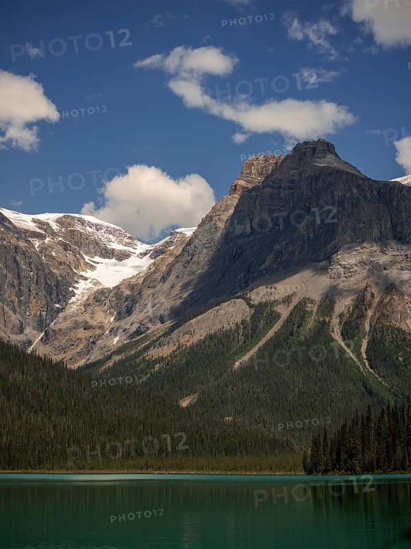 Towers of snowy peaks of the Canadian Rocky Mountains next to Emerald Lake inside Yoho National Park, British Columbia, Canada, North America