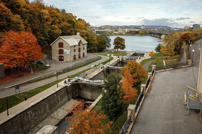 Elevated view of the Rideau canal and locks leading to the Ottawa River, lined by an autumn path with vibrant foliage in Ottawa, Ontario, Canada, North America