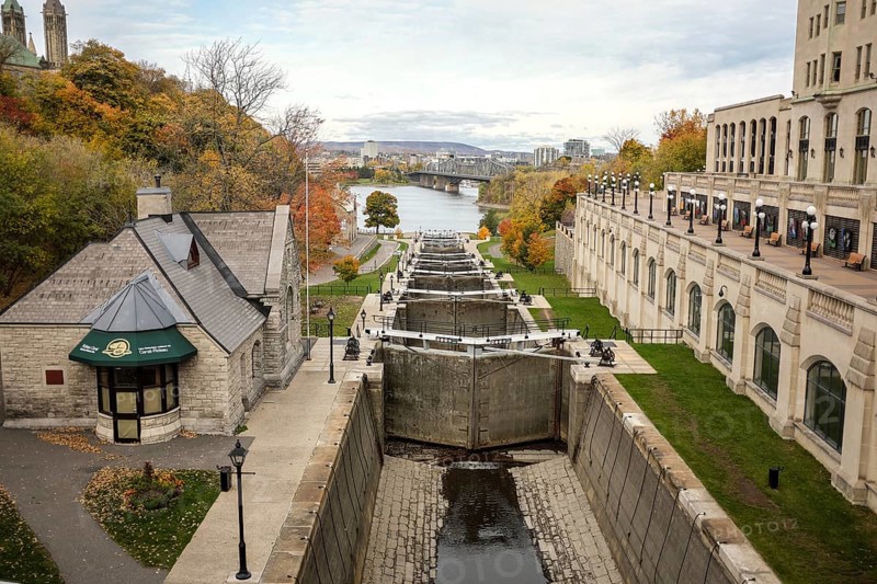 Scenic view of the Rideau Canal locks, leading to the Ottawa River surrounded by autumn trees and historic buildings in Ottawa, Ontario, Canada, North America