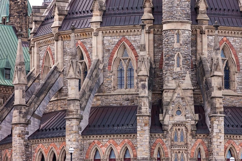 A close-up of the Canadian Parliament Buildings with stone facade with gothic architectural details and spires in Ottawa, Ontario, Canada, North America