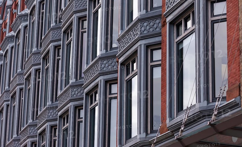 Close-up of a building facade with multiple windows and ornate architectural details, featuring a modern urban feel in Ottawa, Ontario, Canada, North America