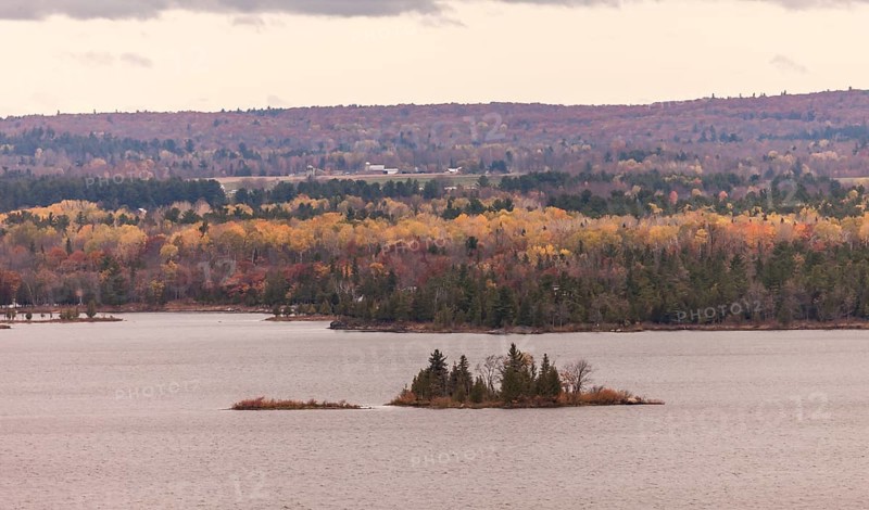 The Ottawa River with small islets surrounded by colorful autumn trees and hills in Ottawa, Ontario, Canada, North America