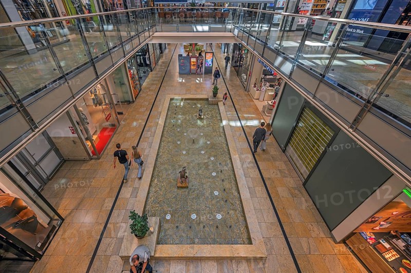 Shops and fountain with frog king in Forum Allgäu, Kempten, Allgäu, Swabia, Germany