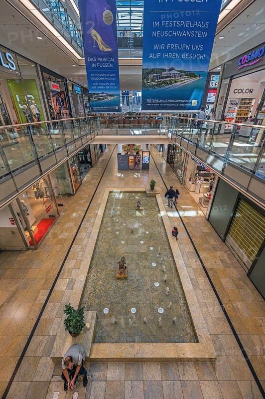 Shops and fountain with frog king in Forum Allgäu, Kempten, Allgäu, Swabia, Germany