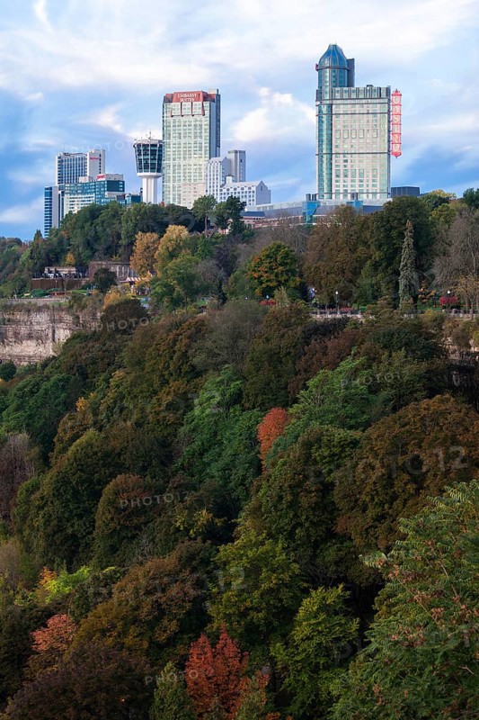 City skyscrapers rise above lush, colorful trees and natural landscape in Niagara Falls, Ontario, Canada, North America