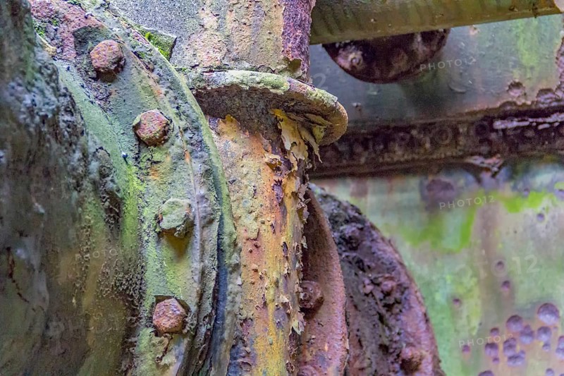 Weathered rundown industrial detail with old corroded metal tubes and fittings