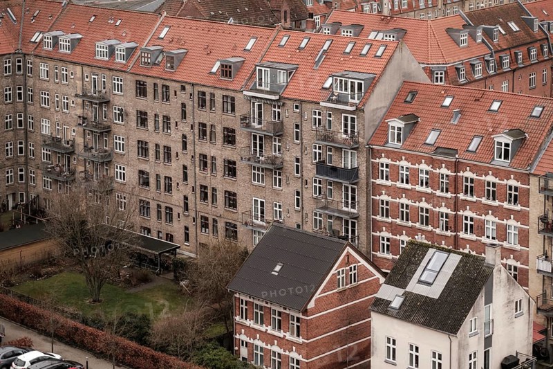 Dense urban scene with red tile roofed residential buildings under an overcast sky in Aarhus, Denmark, Northern Europe