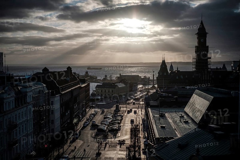 A dramatic city view with a silhouette against a sunset over the Oresund Strait, between Sweden and Denmark, as seen from Helsingborg, Sweden, Scandinavia, Northern Europe