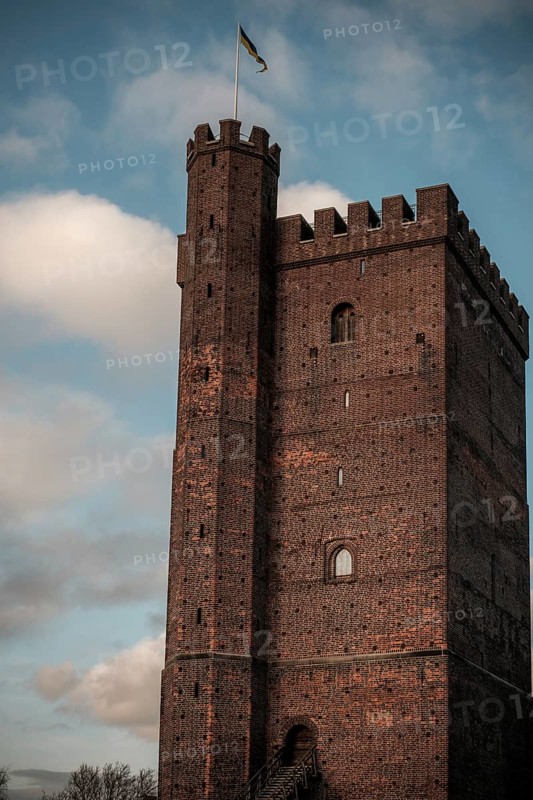 The Karnan medieval tower, built in the early 14th century, with a flag set against a blue sky with clouds in Helsingborg, Sweden, Scandinavia, Northern Europe