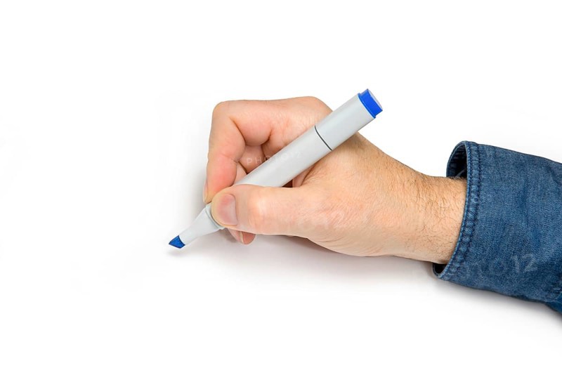 Male hand with felt tip pen in light back