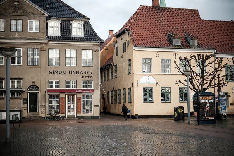 Daytime scene with historic buildings lining an empty cobblestone square in Helsingor, Denmark, Northern Europe