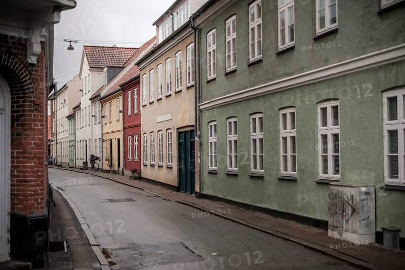 A quiet street with colorful houses and overcast skies in Helsingor, Denmark, Northern Europe