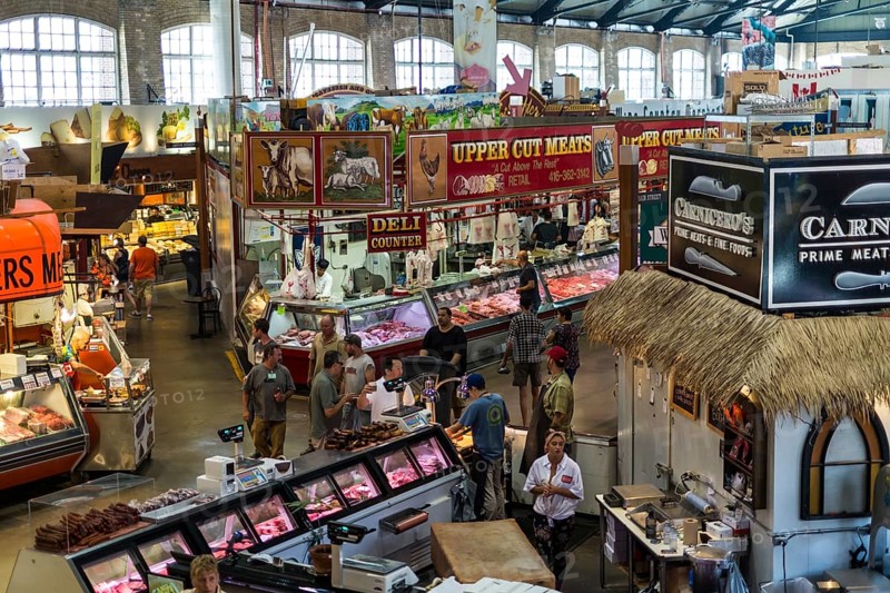 A bustling indoor market at St. Lawrence Market, with meat vendors and colorful displays in Toronto, Ontario, Canada, North America
