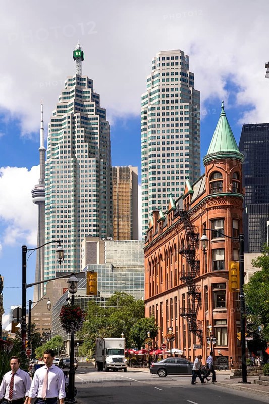 A mix of historic and modern buildings under a bright sky in Toronto, Ontario, Canada, North America
