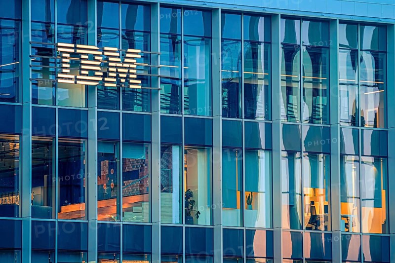 Jan 16, 2025 - Lisbon, Portugal: Day view of IBM office building with glowing logo and sleek glass exterior. Illuminated interior spaces and reflections, innovative spirit and global presence of renowned technology corporation, corporate life