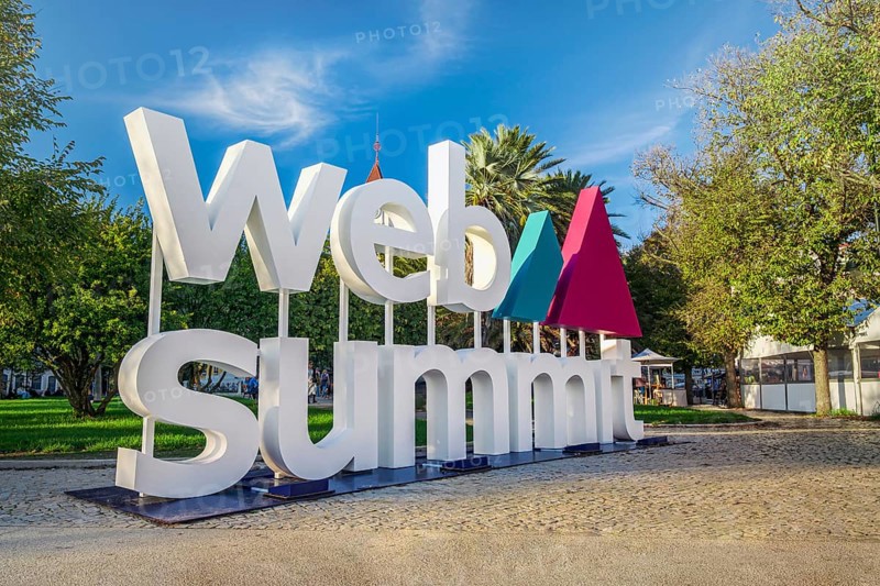 Nov 6, 2024 - Lisbon, Portugal: Large Web Summit sign displayed outdoors in park on sunny day under clear blue sky. Major annual technology conference hosted in Portuguese capital city. Internet technology, emerging technology, marketing, AI solution