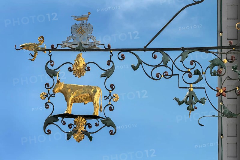 Wrought iron nose plate with golden bull in Kisslegg, Allgäu, Baden-Württemberg, Germany