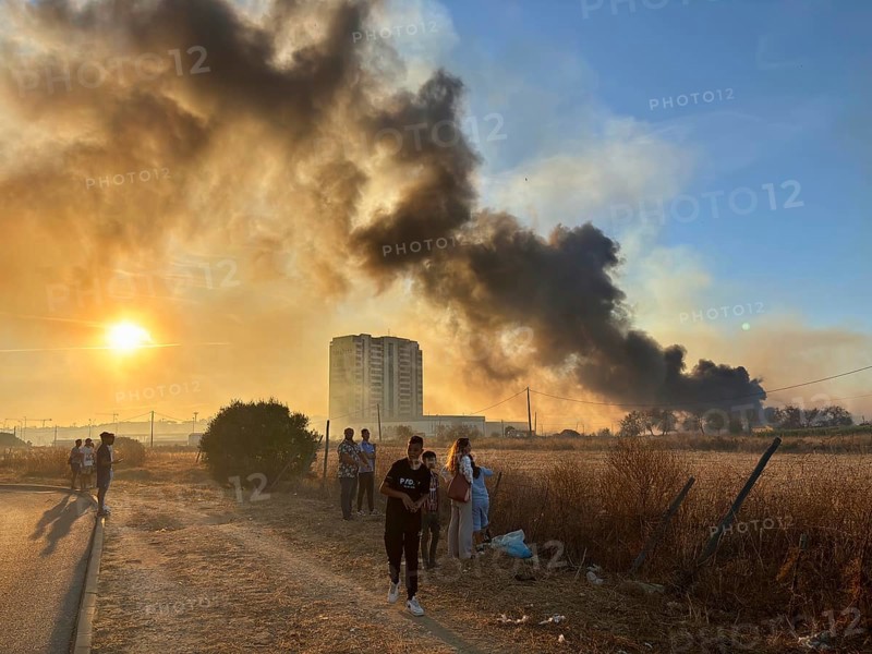 Faro, Algarve - September 21, 2025: People watching a big fire in the suburbs of Faro, capital city of Algarve. People watching