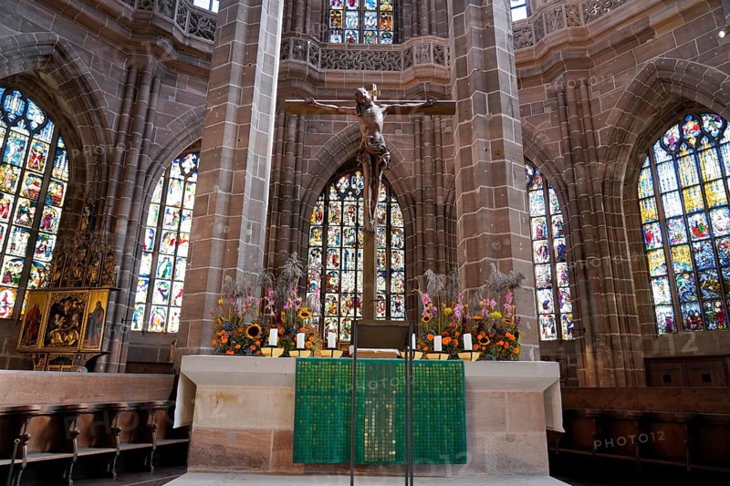 Church altar with cross and colourful stained glass windows depicting biblical scenes, St. Lawrence Church, Nuremberg, Middle Franconia, Franconia, Bavaria, Germany