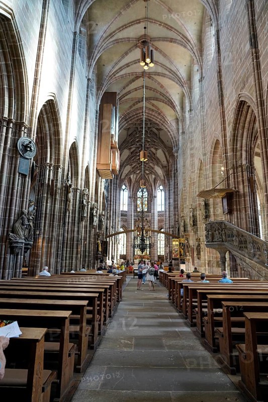 Long nave with high Gothic vaults and people exploring the space, St. Lawrence Church, Nuremberg, Middle Franconia, Franconia, Bavaria, Germany